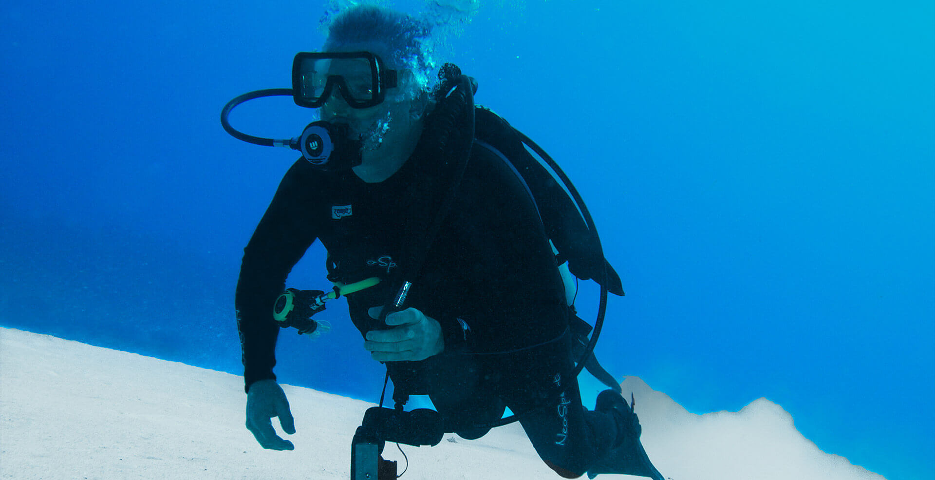 man diving in cozumel waters